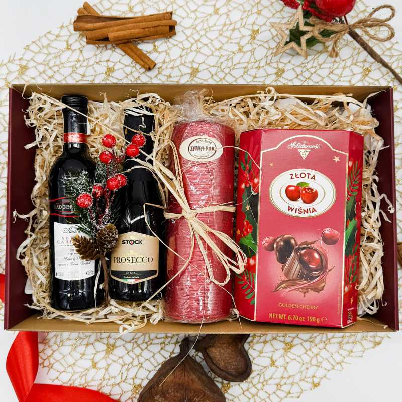 Luksusowy gift box z winem i Prosecco ozdobiony świątecznymi dekoracjami